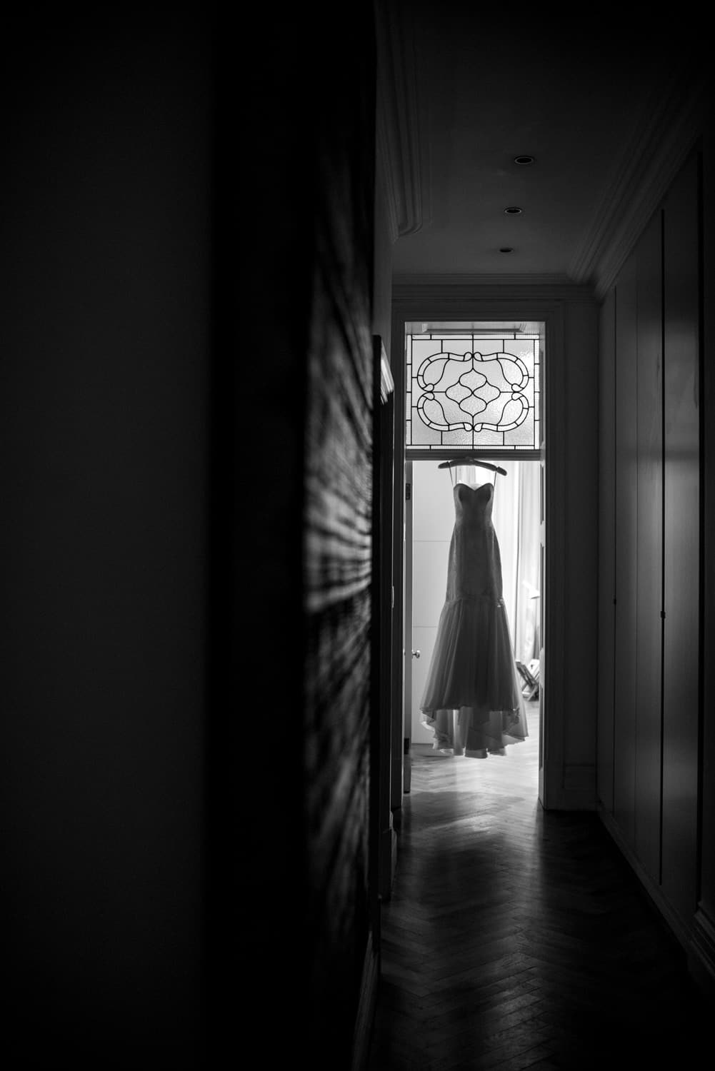 wedding dress hanging in door way