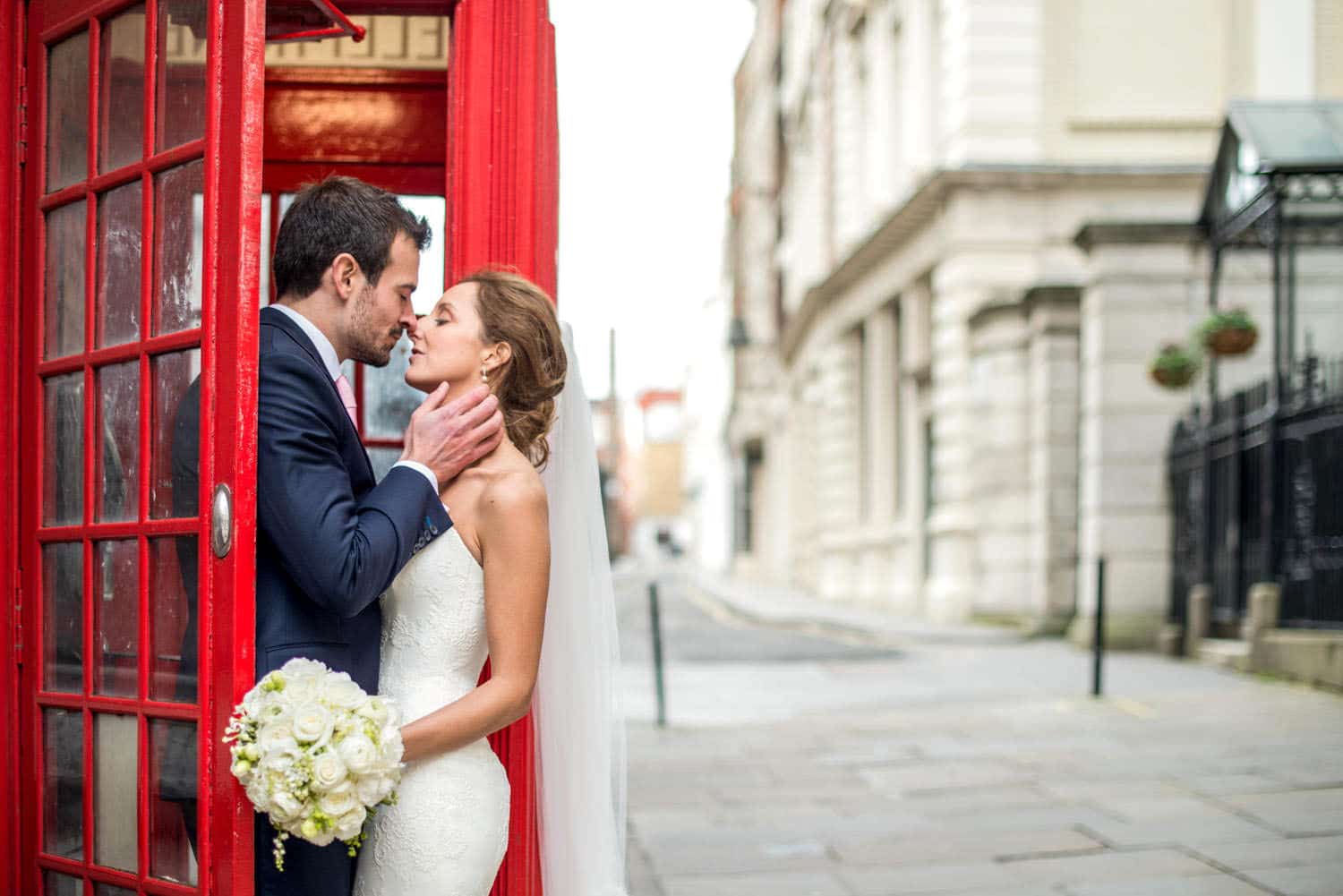 bride and groom wedding portrait by red telephone box