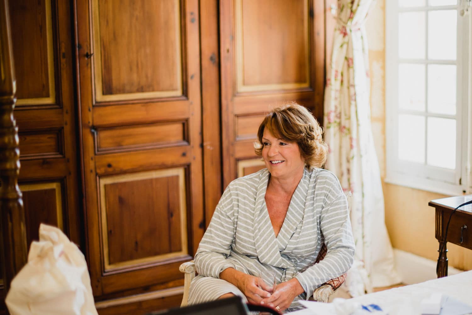 mother of bride in bridal suite of Chateau de Lacoste wedding venue