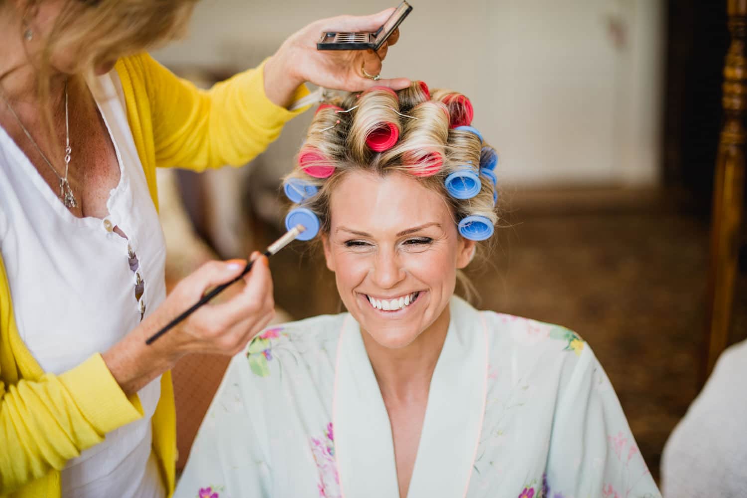 bride laughing during wedding preparations