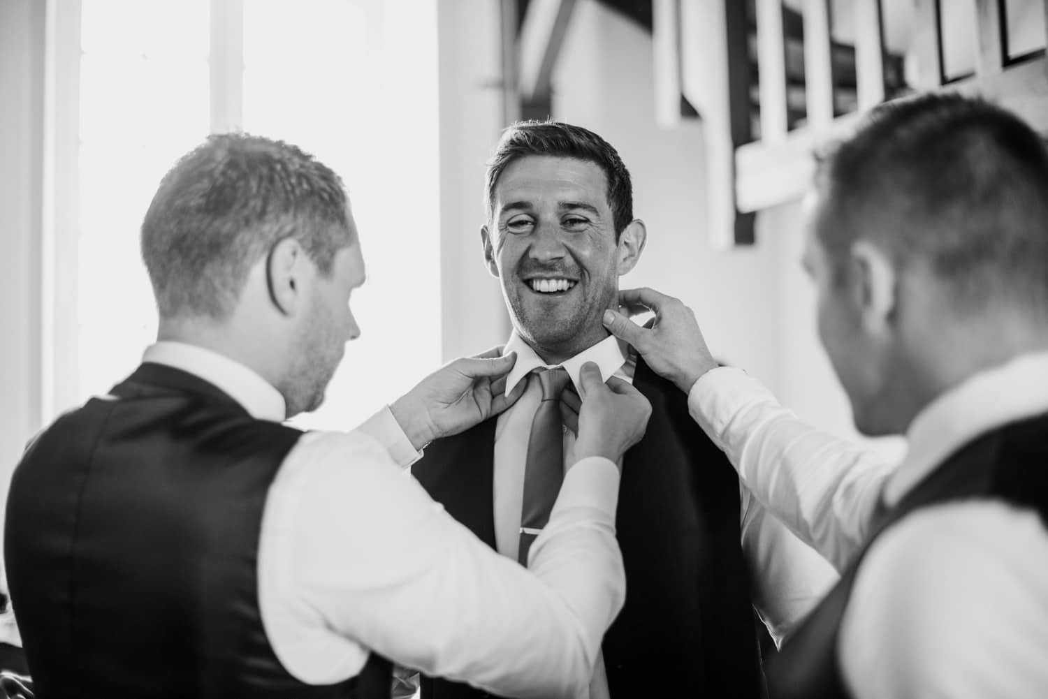 groom getting ready in barn at Chateau de Lacoste wedding venue