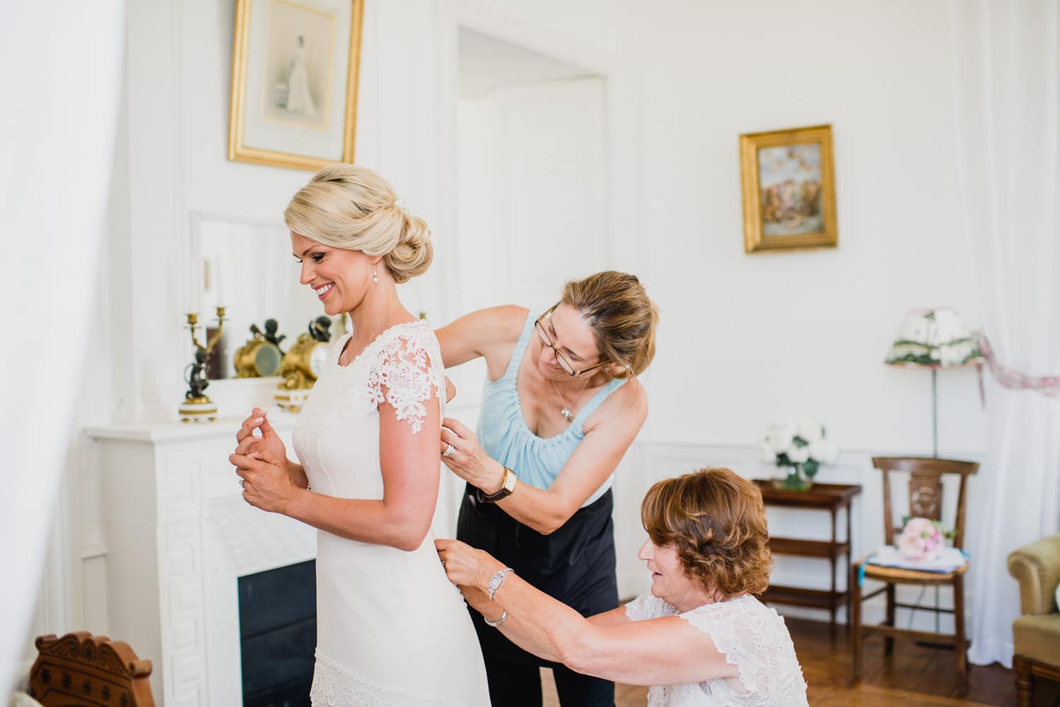 bride getting into her dress at Chateau de Lacoste wedding