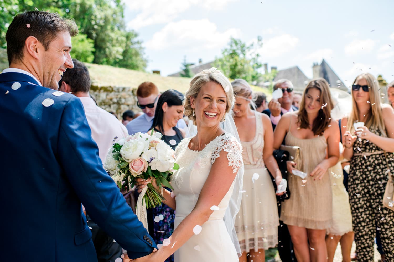 bride and groom leaving the chapel at wedding ceremony in the chapel of Chateau de Lacoste