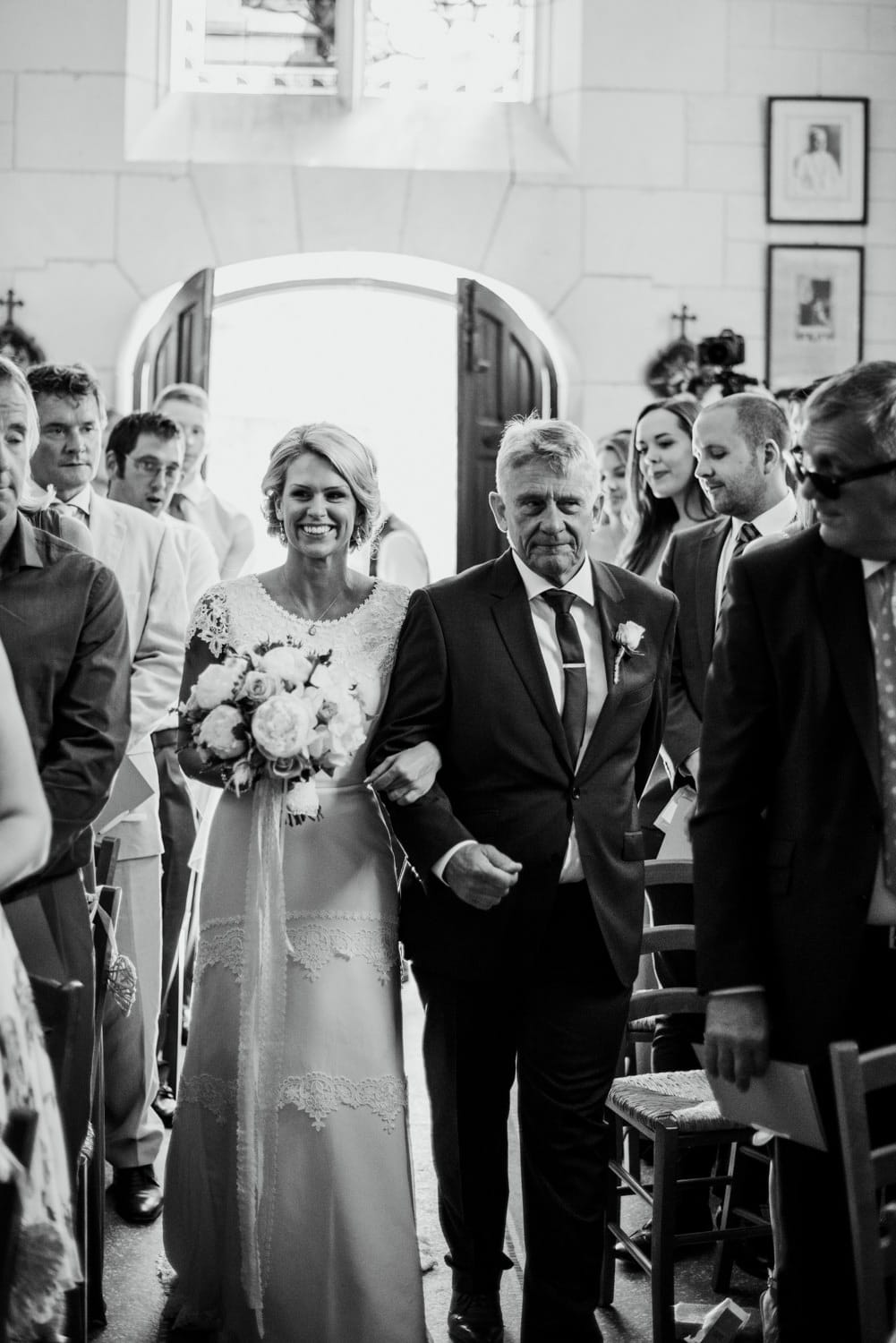 bride walking down the aisle in the chapel at Chateau de Lacoste wedding venue in France