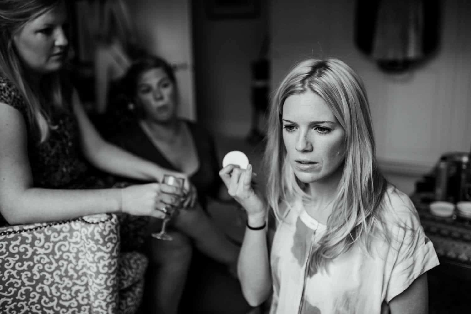 bride concentrating applying her make up