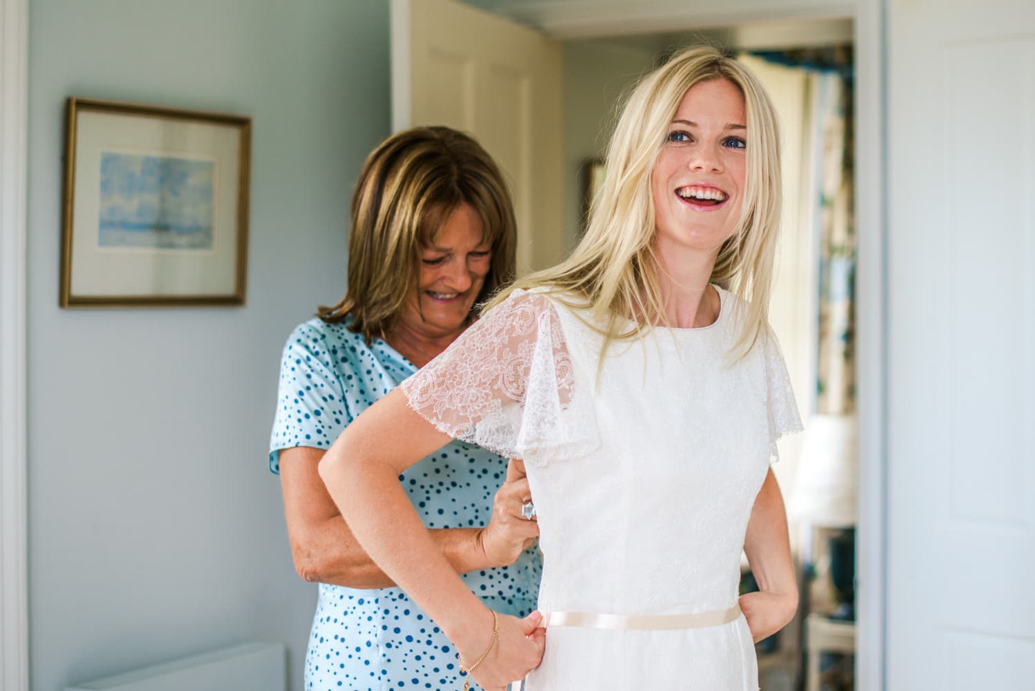 bride getting into wedding dress at Dorset country wedding