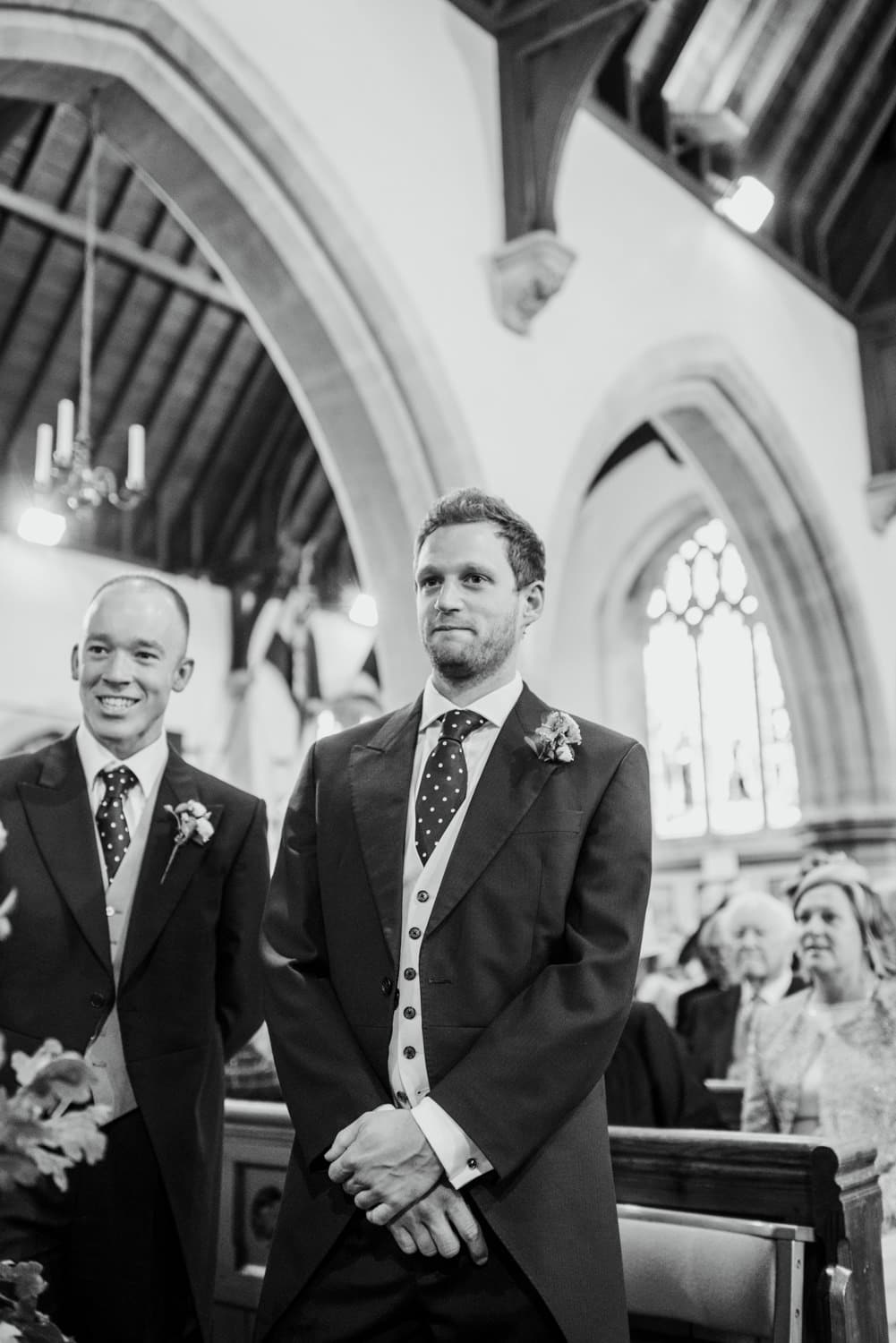 groom waiting for bride to walk down the aisle in church