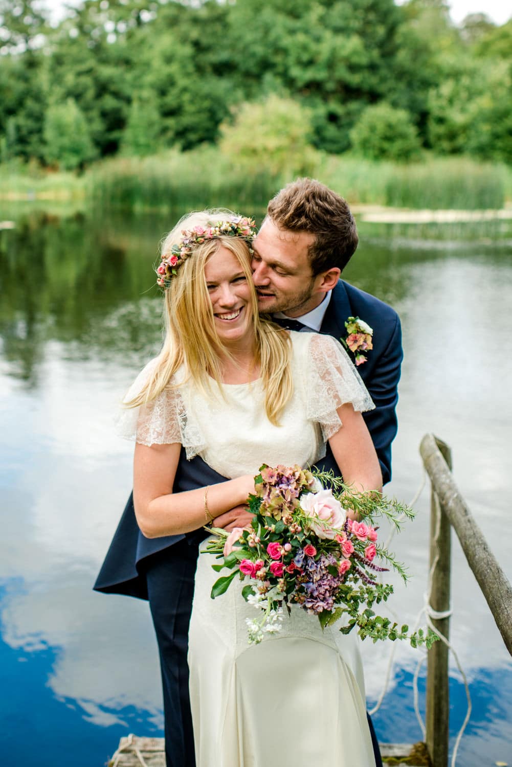 bride and groom portrait by lake