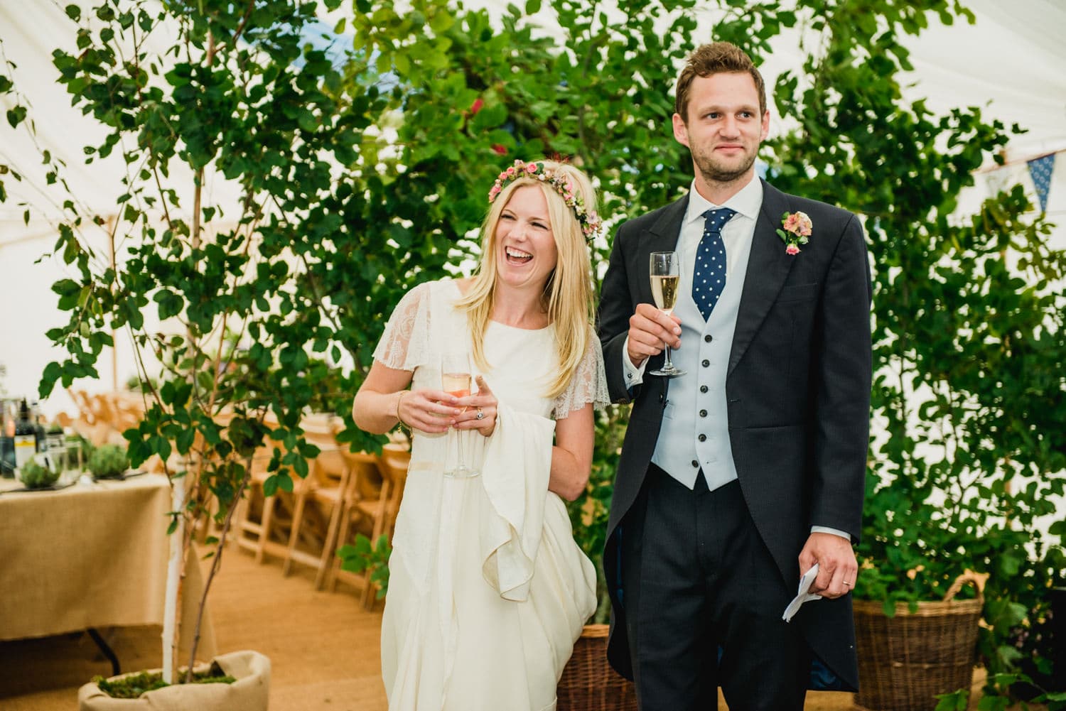 bride and groom during speeches in marquee