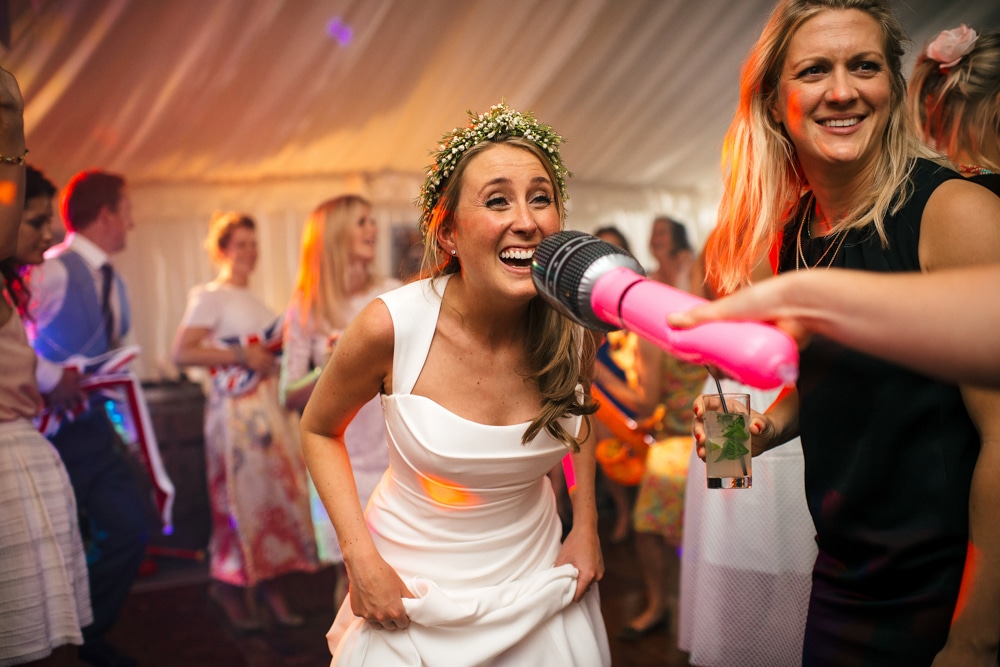 bride singing into inflatable microphone