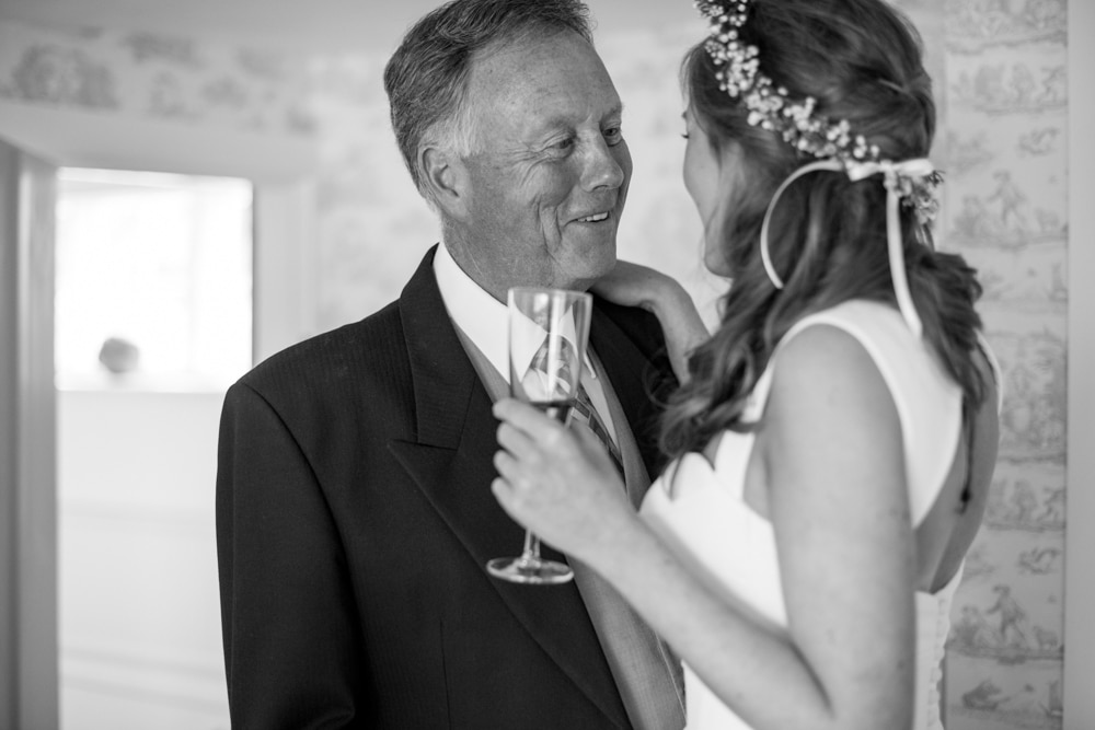Father of bride seeing his daughter for the first time in her dress