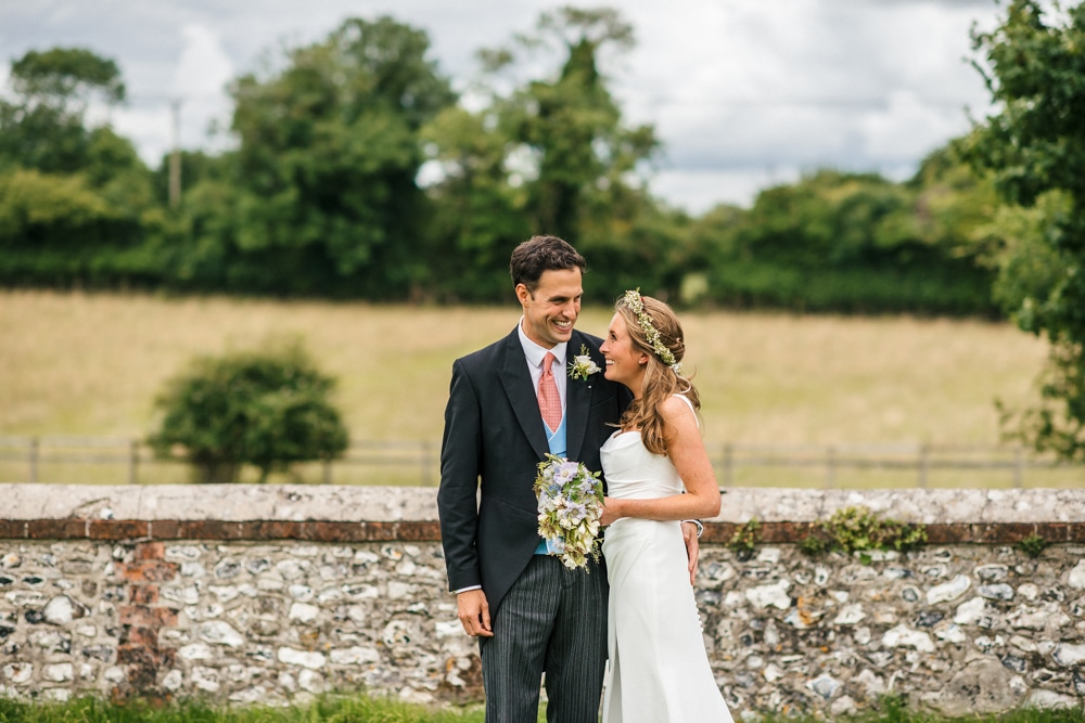 portrait of bride and groom in field