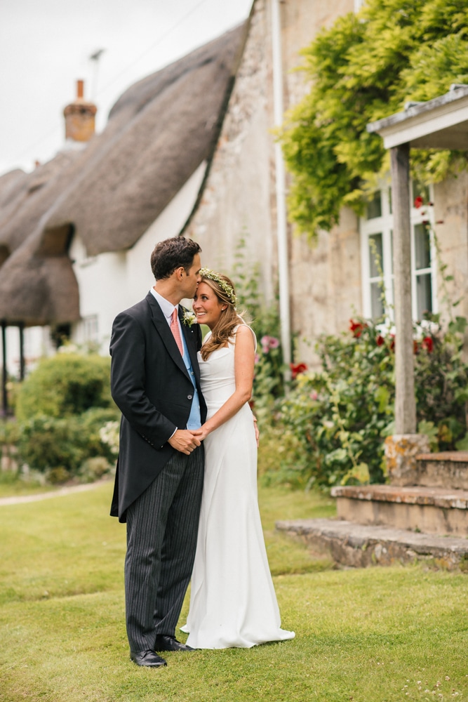New Forest photography, bride and groom in village with thatched houses