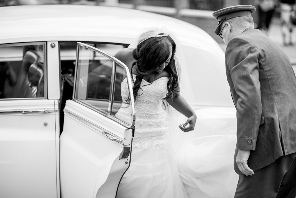 Bride exiting wedding car