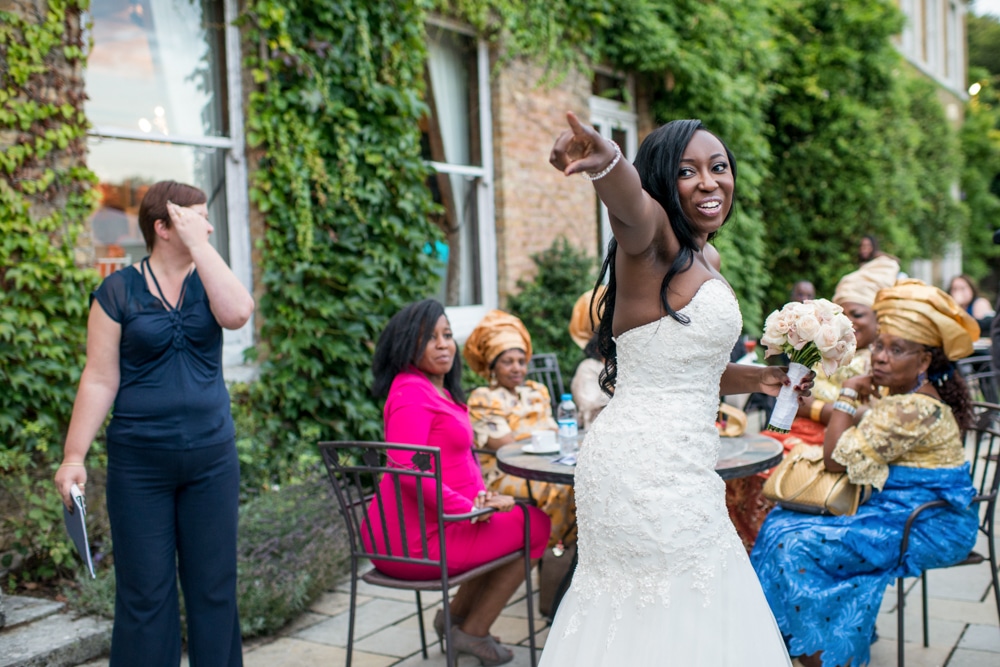 Bride throwing wedding bouquet at High Elms Manor Watford