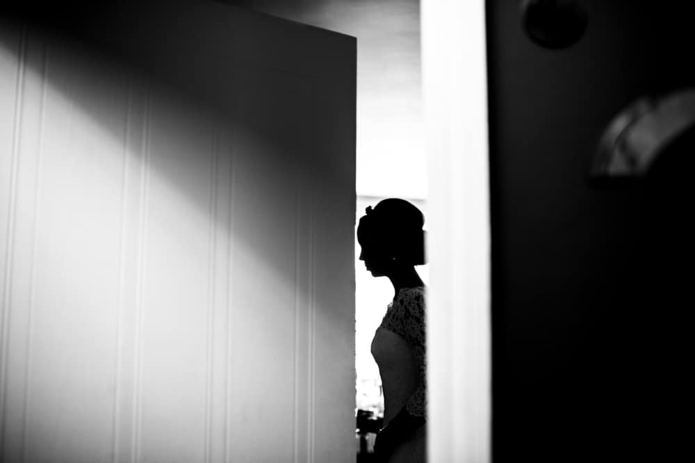 Silhouette of bride in doorway