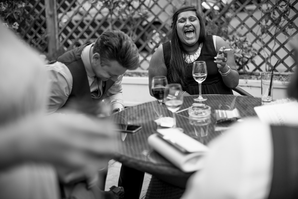 guests laughing, drinking and smoking at bluebells restaurant wedding