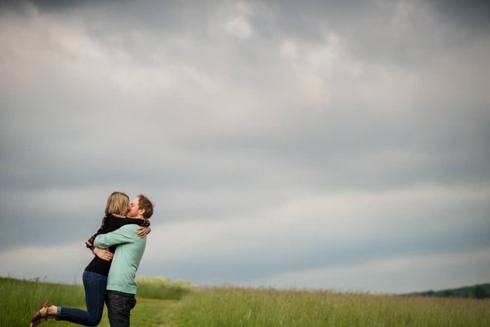 couple embracing with dramatic sky in background