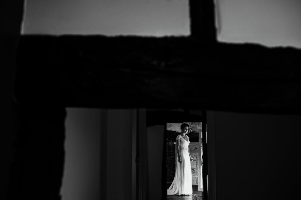 bride framed by timber doorway