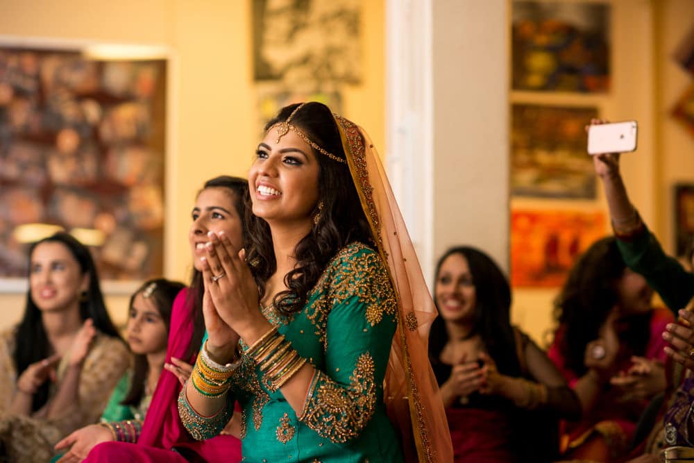 bride watching dancers at her Mehndi