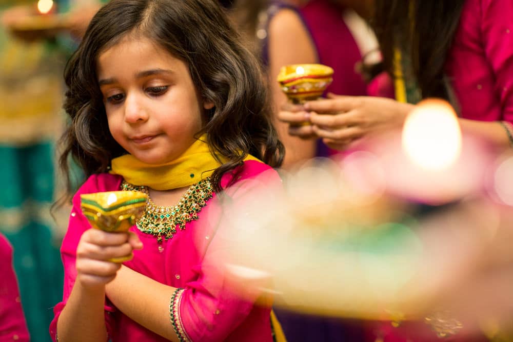 child holding candle at Mehndi