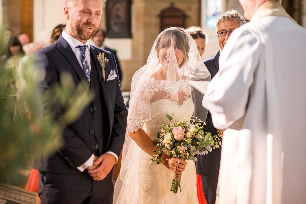 bride meeting groom at the alter at St. John Of Jerusalem Church