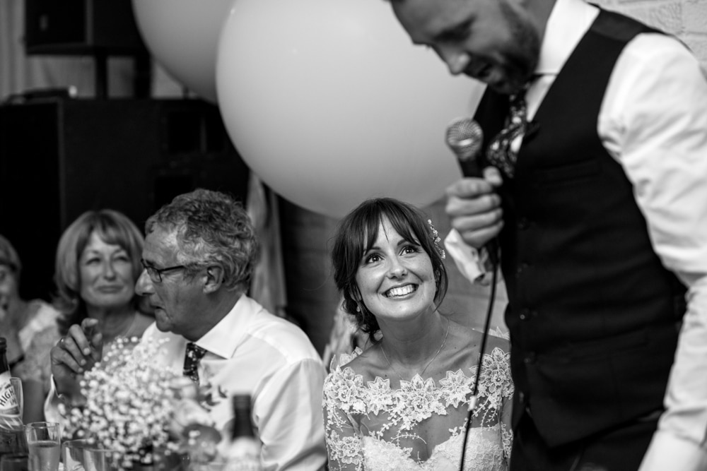 grooms speech at London Fields Brewery wedding bride smiling