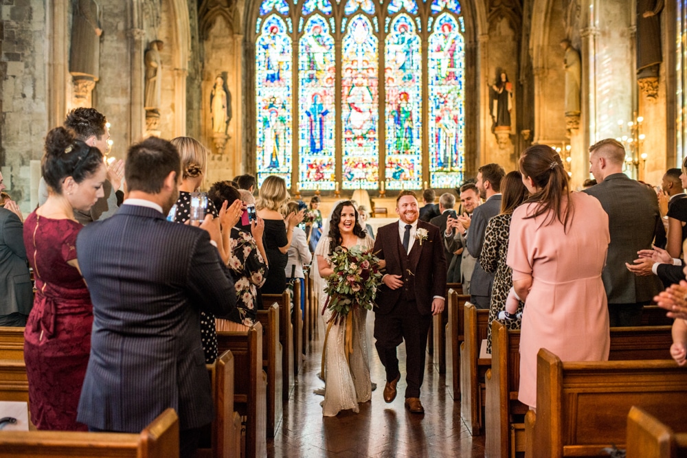 bride and groom walk down the aisle at st etheldreda's church