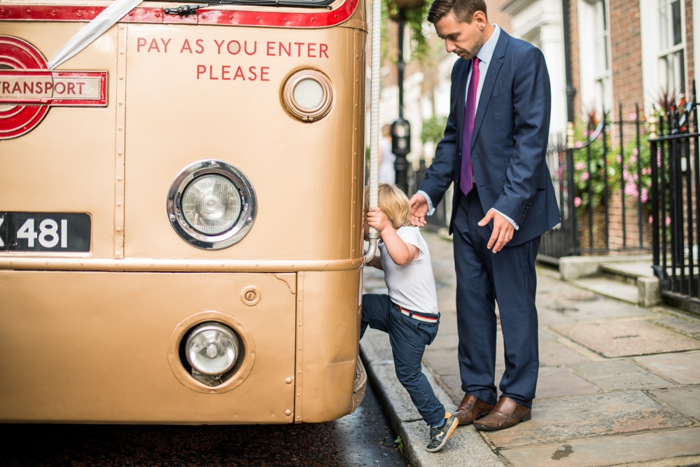 little boy getting onto vintage bus