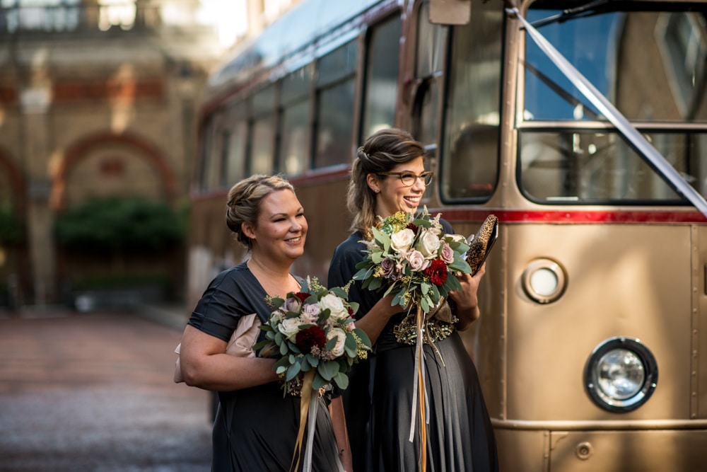 bridesmaids next to vintage gold wedding bus