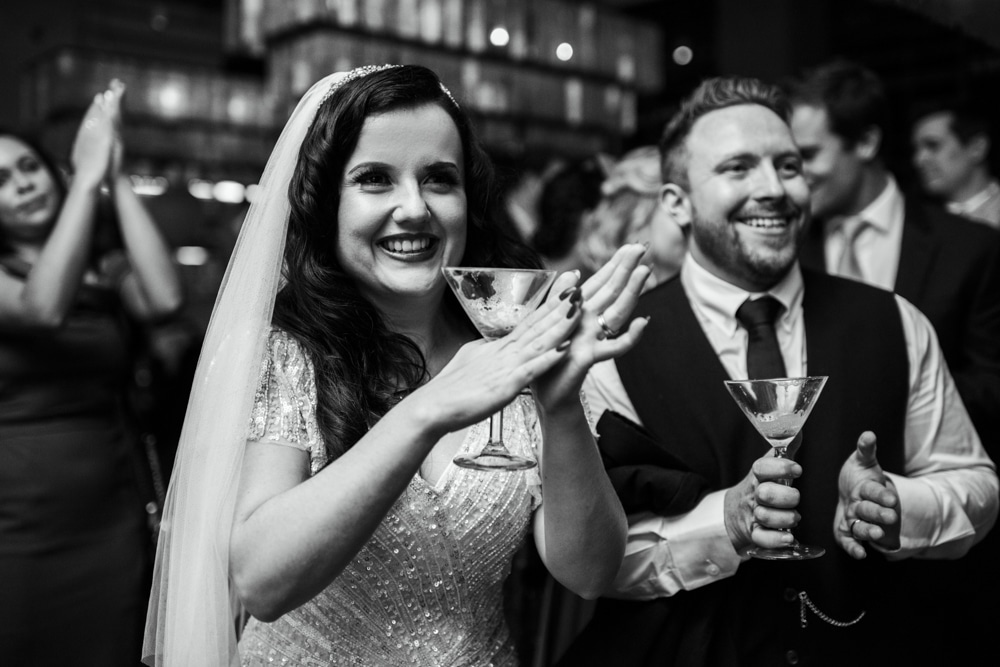 Bride and groom clapping at wedding