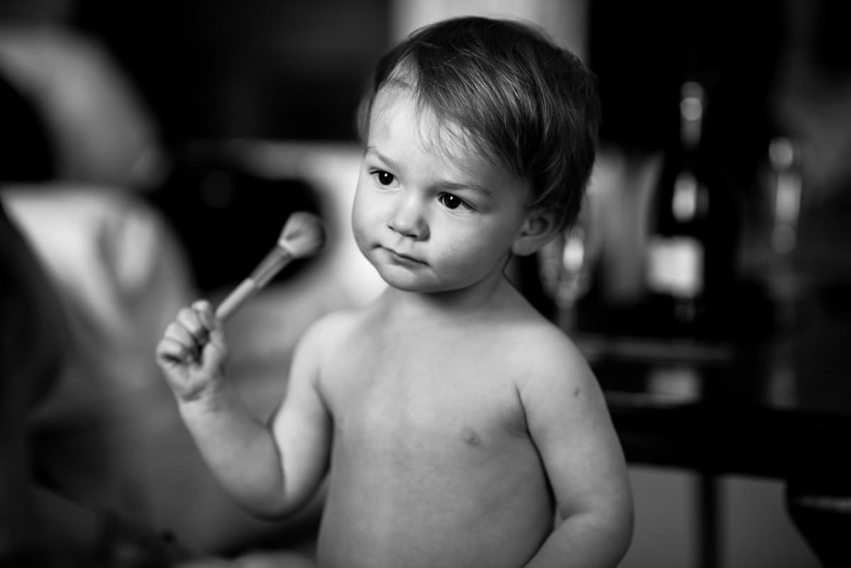 kid at wedding, with make up brush