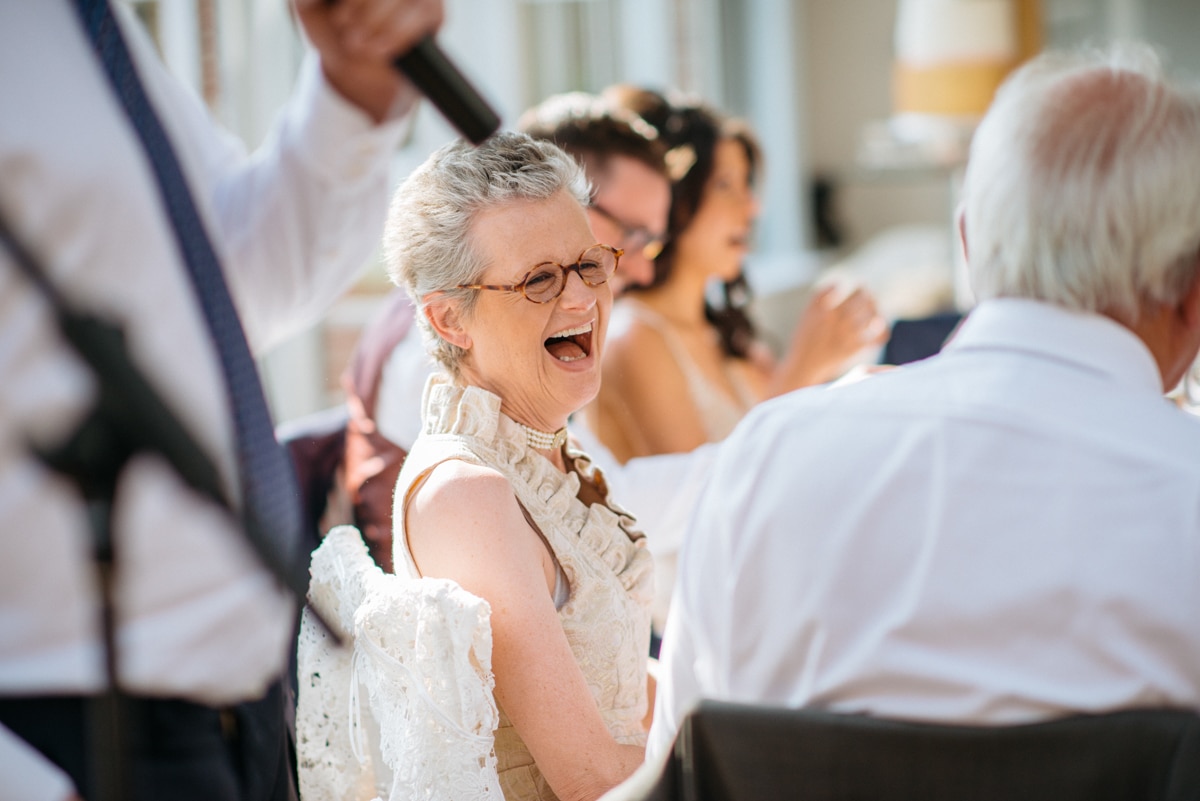 mother of groom laughing during the speeches