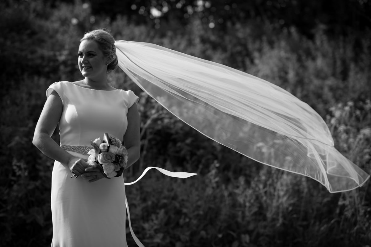 bride with veil blowing in wid