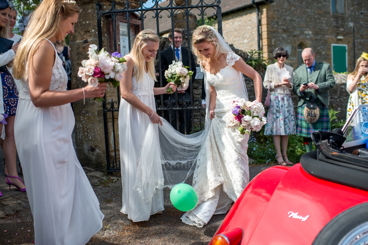 bride popping ballons, Dorset wedding