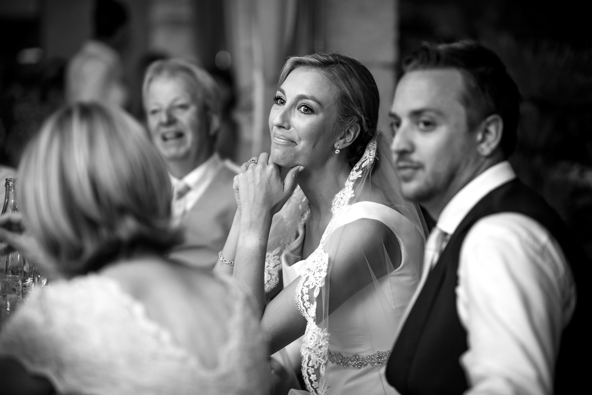 bride smiling during the speeches