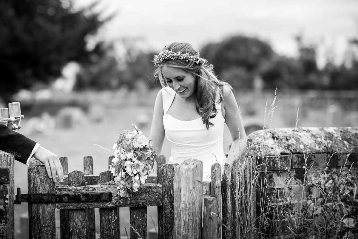 Bride walking through kissing gate, country wedding