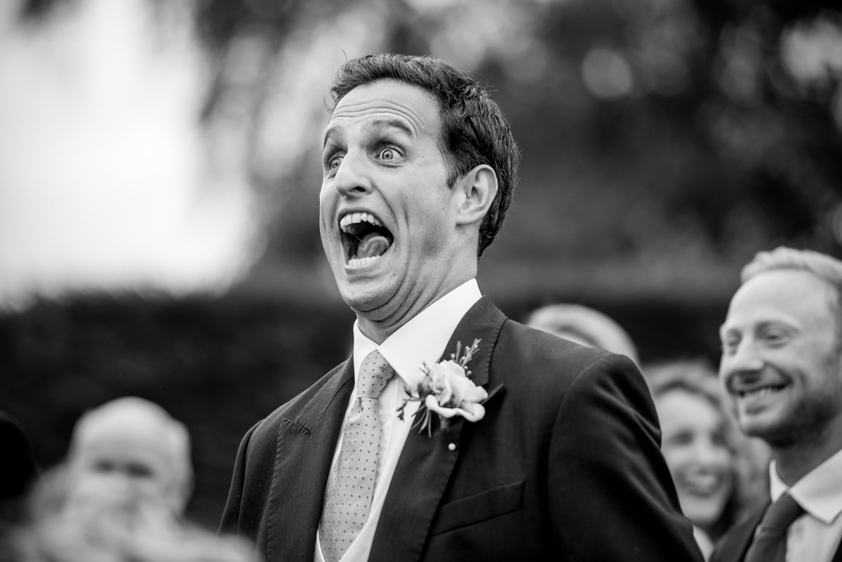 groom laughing during speeches