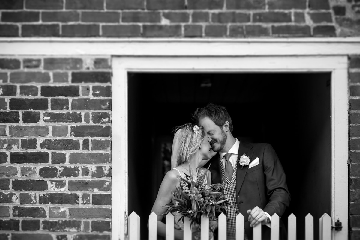 bride and groom kissing in stables