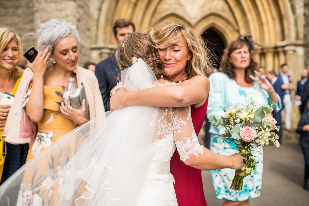 Guest hugging bride