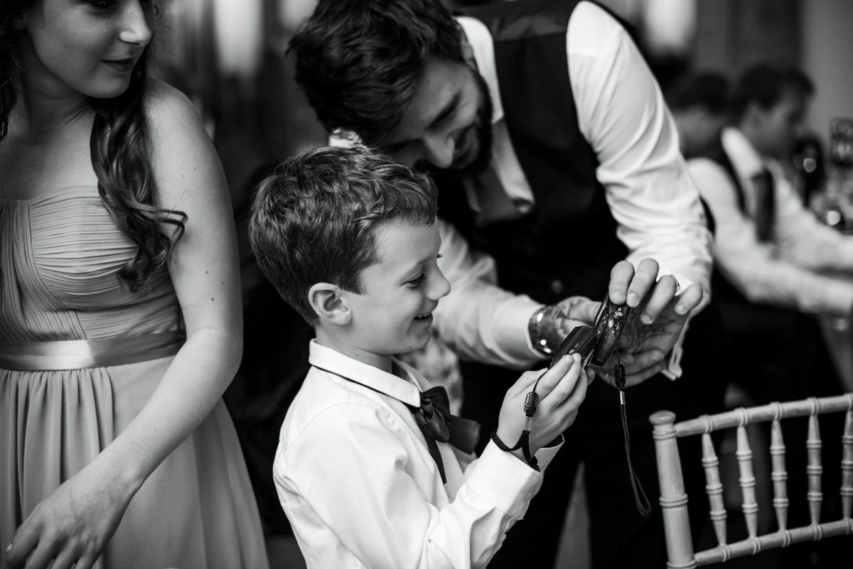 Pageboy being shown how to use a camera