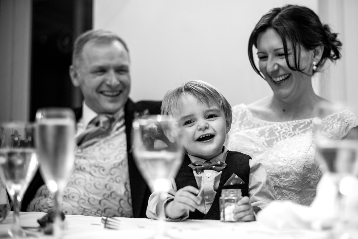 Bride and groom with son during wedding speeches