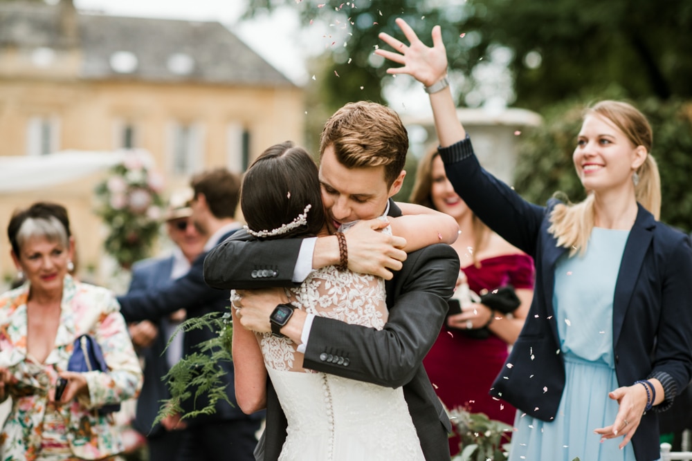 celebratory hugs from guests after wedding ceremony