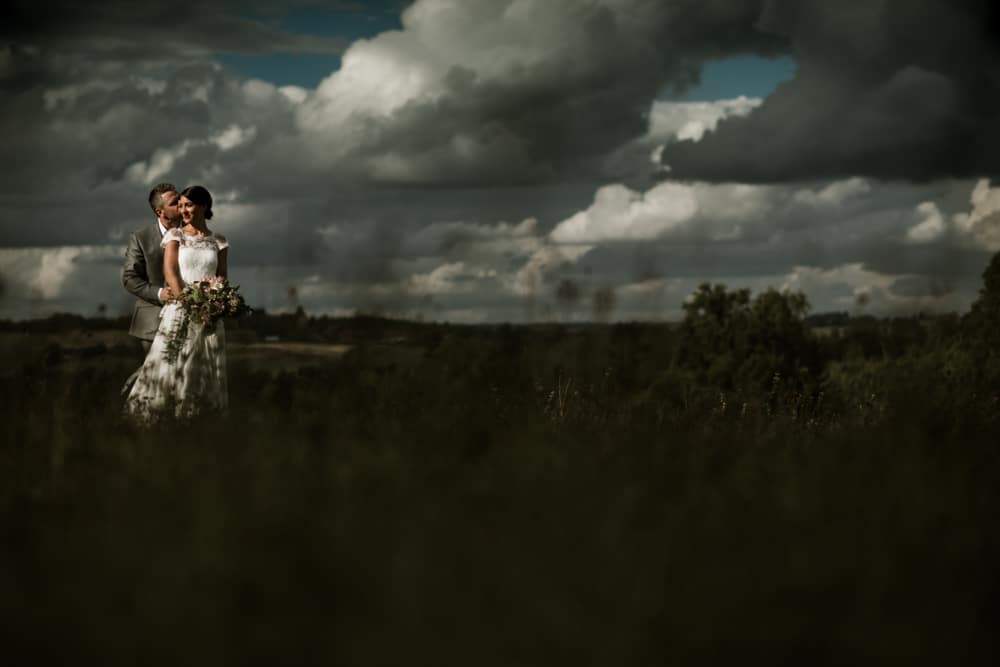 dramatic clouds and light during wedding portraits