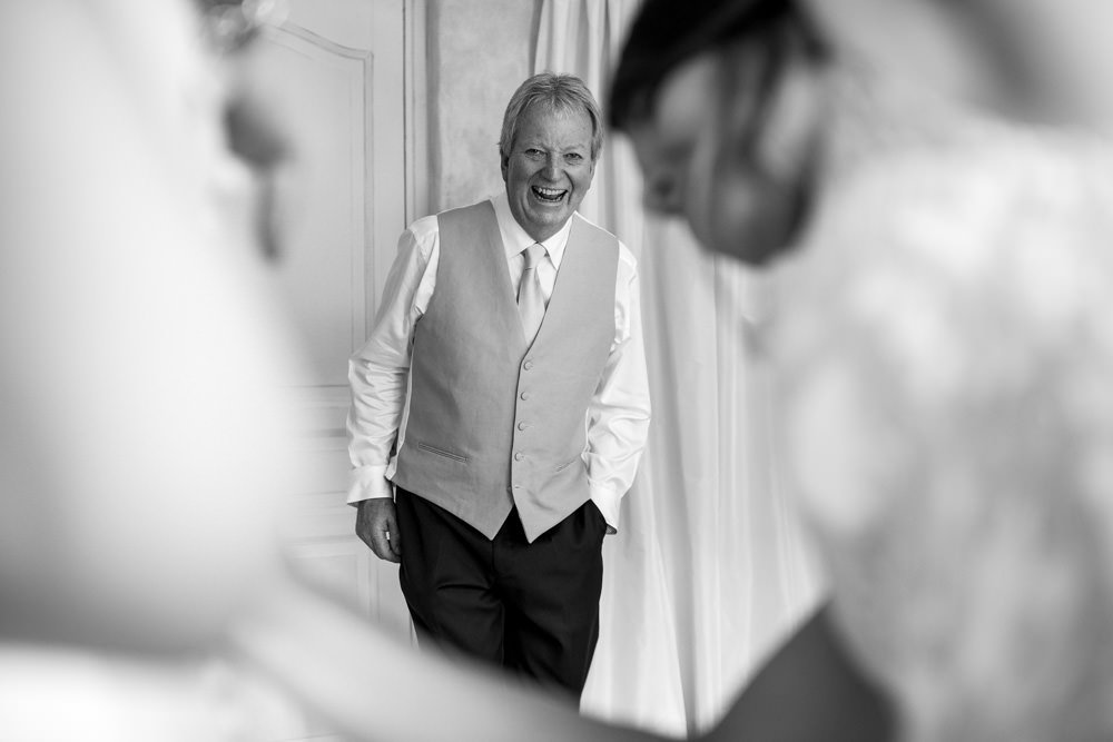 father of the bride seeing daughter in dress