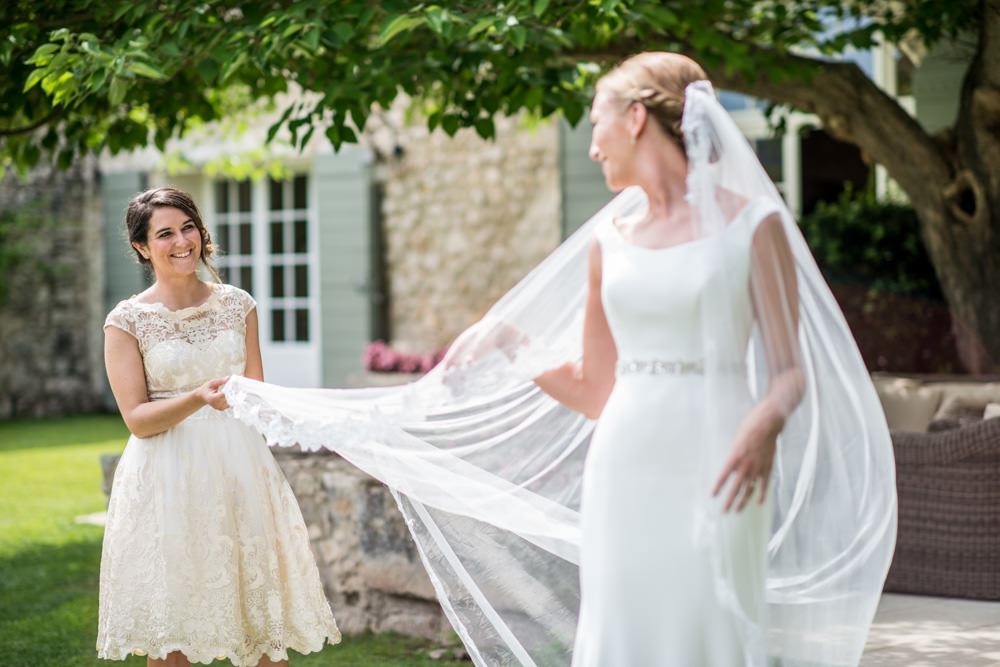 bridesmaid holding wedding veil