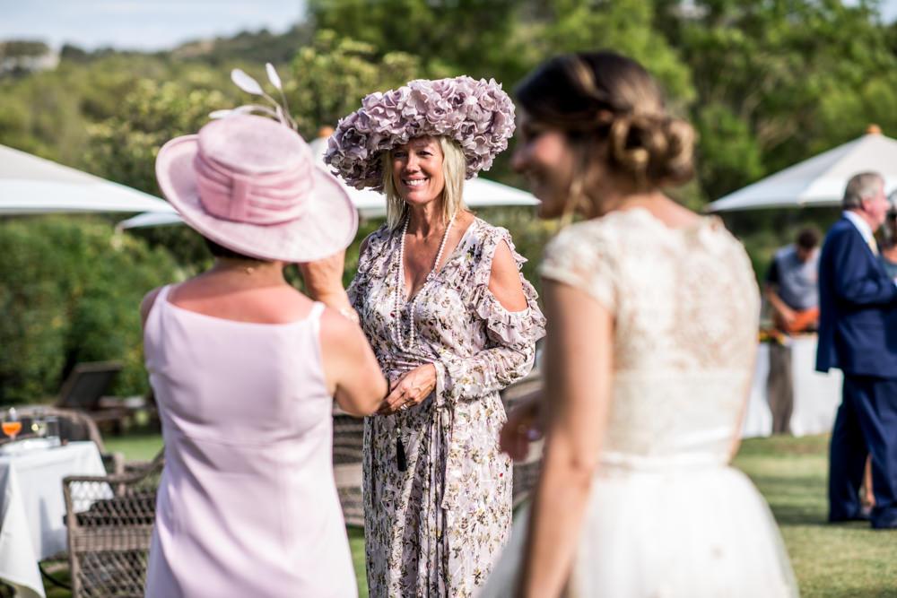Guests at wedding lady wearinglarge pink hat