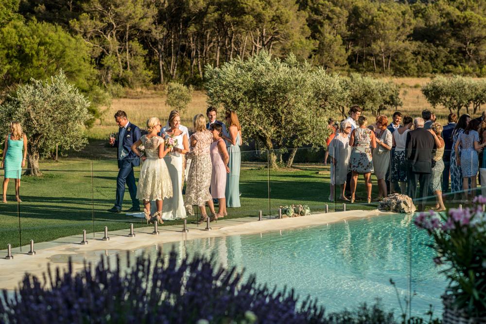 wedding guests around pool in France