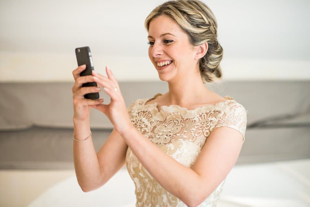 bridesmaid taking picture on phone