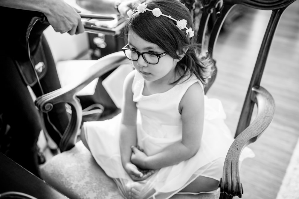 flower girl getting her hair done at wedding